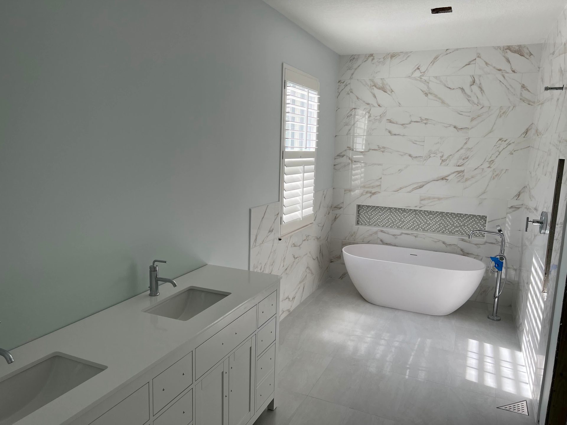 Remodeled bathroom with walk-in shower and custom vanity by Urban Remodeling, Vero Beach