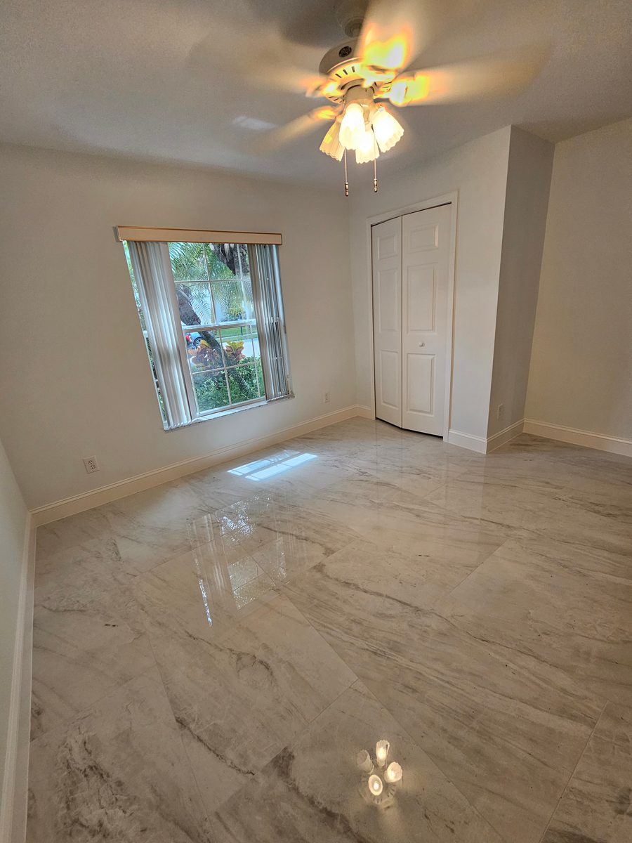 Room with new porcelain tile floor and fresh trim