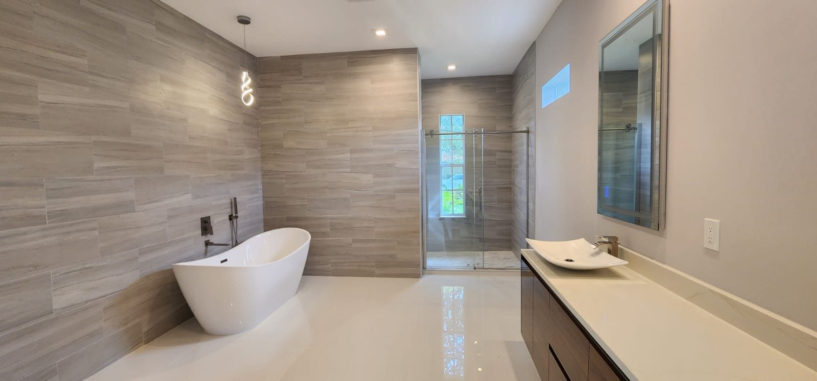 Bathroom with soaking tub and wood-look tile wall