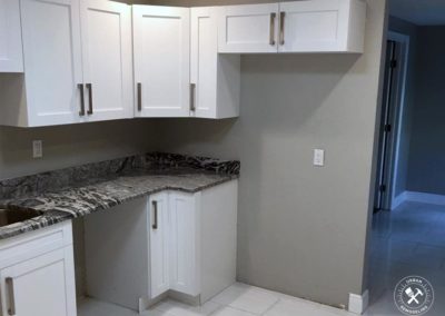 Remodeled Kitchen in vero beach with gray counter-top and white cabinets