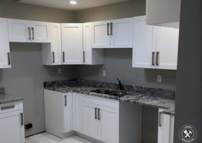 Remodeled Kitchen in vero beach with gray counter-top and white cabinets