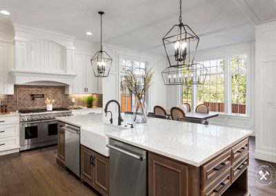 Beautiful kitchen in new traditional style luxury home, with quartz counters, hardwood floors, and stainless steel appliances