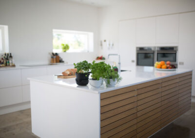White Kitchen with an wooden isle, white marble countertop. Kitchen Remodeling in Vero Beach